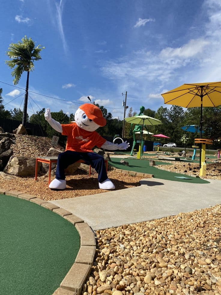 Swing mascot posing on the mini golf course